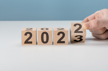 happy 2023 new year concept, Flipping of wooden cube block change from 2022 to 2023. Start new year 2023 with goal plan, goal concept, action plan, strategy, new year business vision.