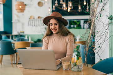 woman is using laptop in cafeteria