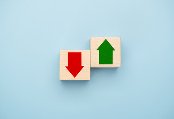 Green up arrow in bright side and red down arrow in dark side which print screen on wooden cube...