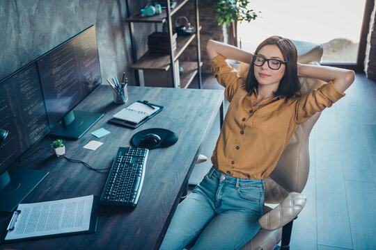 Portrait of attractive dreamy calm girl geek technician sitting resting in chair nap at workplace workstation indoors