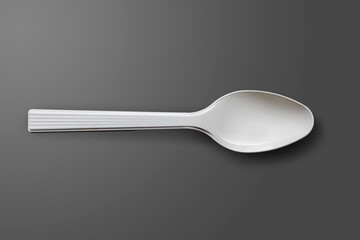 Top view of the plastic spoon, Dark Gray Background, flat lay