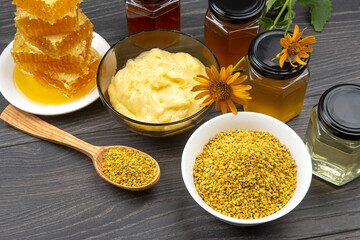 Fresh flower honey of different varieties, pollen and honeycomb with spoons on a wooden background. Organic Vitamin Health Food