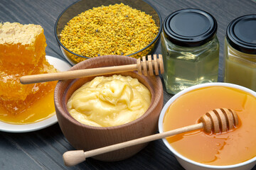 Fresh flower honey of different varieties, pollen and honeycomb with spoons on a wooden background. Organic Vitamin Health Food