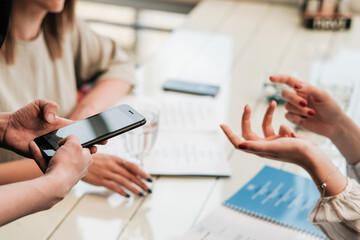 Close Up of Female Hands at Table, Two Women Making Order to Waiter with Smartphone in the Restaurant