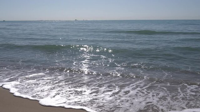 Mediterranean sea with sun shining on sea and waves glinting Villajoyosa Spain Costa Blanca the Med