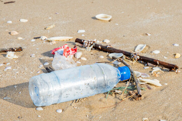 Plastic bottle or garbage on the sand beach.