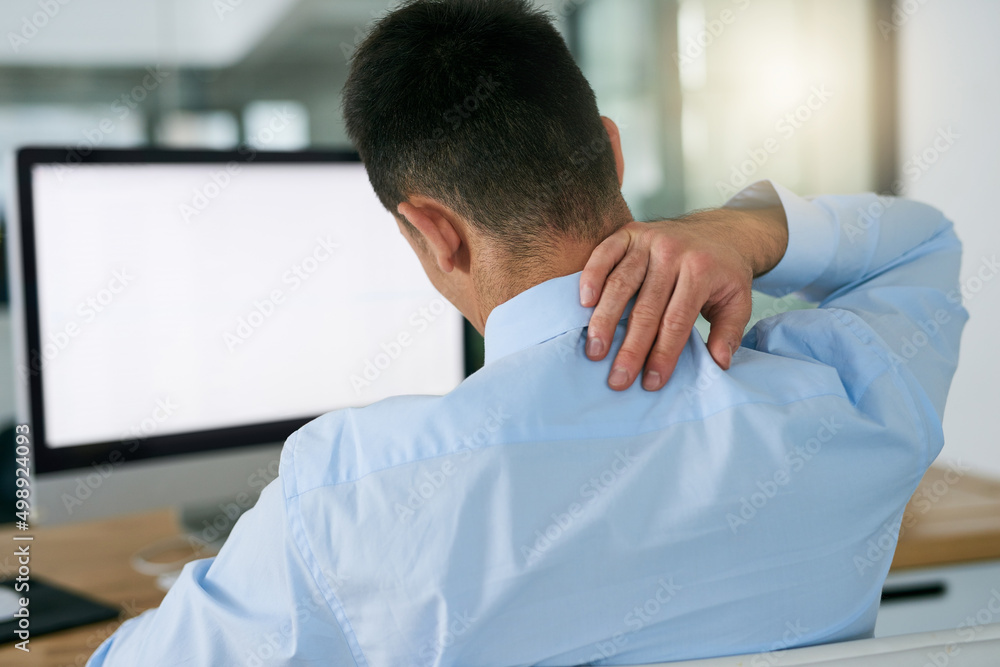 Sticker Bad posture takes it toll. Rearview shot of a young businessman holding his neck while sitting at his desk.