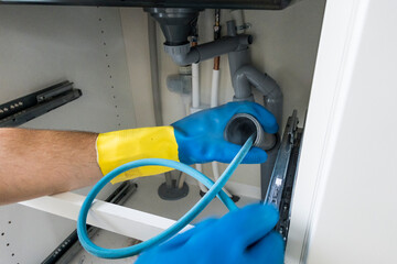 Stockholm, Sweden, April 12, 2022 A plumber at work in an apartment.