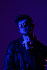 Portrait young man in sunglass isolated gradient violet color background