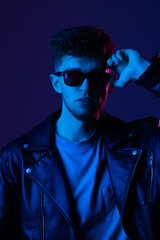 Portrait young man in sunglass isolated gradient violet color background