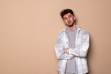 Young man isolated on beige background smiling happy and confident