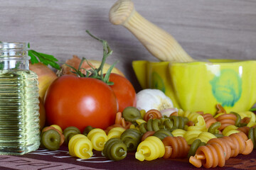 Healthy foods, colored pasta, tomatoes and more ingredients, which provide well-being to our body.