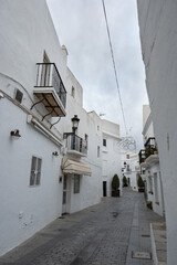 Local streets of the white Spanish Andalusian town of Vejer de la Frontera in a cloudy winter day