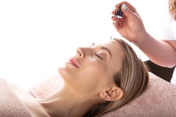 Fototapeta premium Beauty expert performing serum application for skin care.