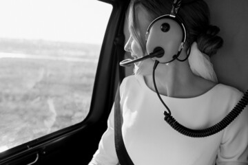  The bride is sitting in a helicopter. Black and white photo