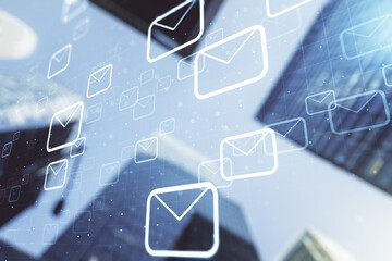 Double exposure of abstract virtual postal envelopes hologram on modern skyscrapers background. Electronic mail and spam concept