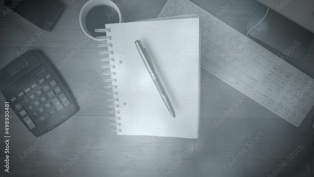 Poster animation of lights over notepad, calculator and keyboard on desk