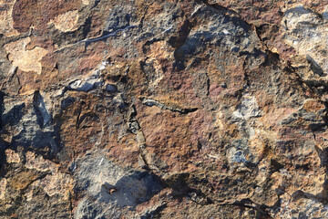 Rough bust fractured stone texture material macro closeup.