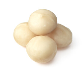 Unshelled macadamia nuts isolated on white background.