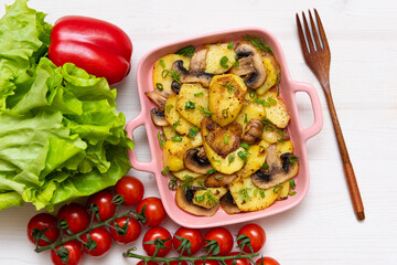 Homemade baked Boulanger on a wooden table with cherry tomatoes and lettuce leaves. delicious European cuisine.