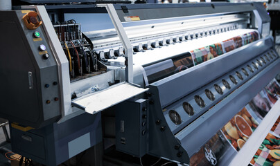Industrial technician operating corrugated cardboard digital inkjet printer. Printing industry. - obrazy, fototapety, plakaty