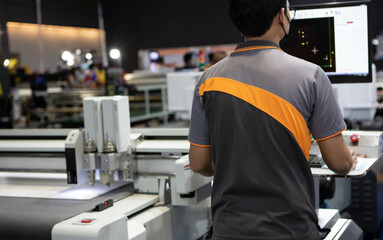 Industrial technician operating CNC laser cutting machine. Industrial manufacture.