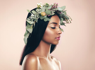 Revelling in natural beauty. Studio shot of a beautiful young woman wearing a wreath while posing...