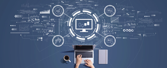 Stock trading theme with person working with a laptop