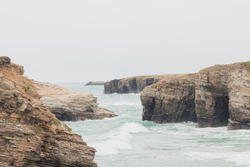 Cliffs located in the touristic beach of the Cathedrals in Lugo, Spain, during a rainy day, with...