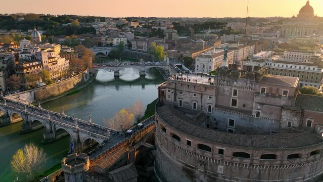Sunset at Castel Sant'Angelo and San Pietro in Rome. Aerial view of the Tiber river, its bridges and St. Peter's, Vatican City. Center city of Roma, Italy in the evening