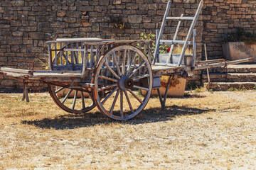 Medieval wooden vehicle  with metal tire on wheel rim ready to move, engineering ideas