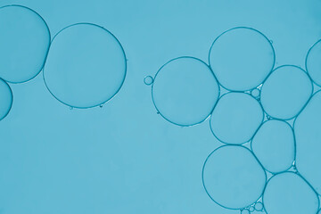 Oil and water blob created pattern bubbles on an art image baby blue background.