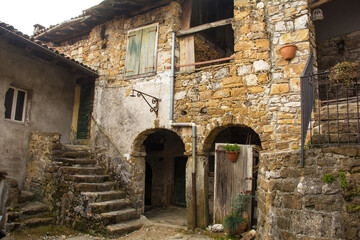 Fototapeta na wymiar Historic disused residential buildings in Poffabro, a medieval village in the Val Colvera valley in Pordenone province, Friuli-Venezia Giulia, north east Italy 