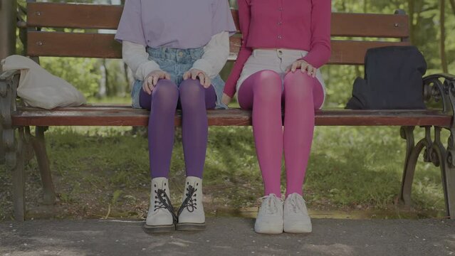 Teenagers dressed in bright tights. Video of details where only tights and girls' hands are visible.