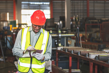 African American man workers,  checking and writing material report for used in industrial production, to working people and industry concept.