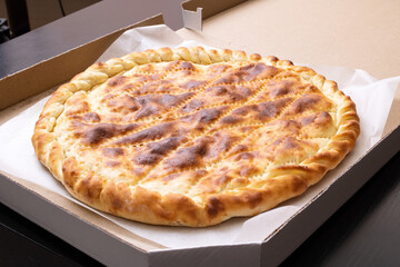 Ruddy Ossetian closed pie in the box
