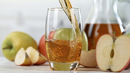 Fresh Apple Juice Being Poured in a Glass, Close-up.