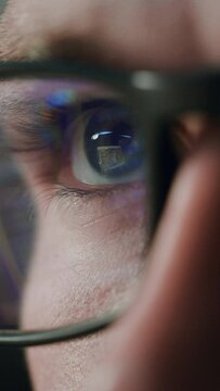 Vertical Screen. Close-up Portrait of Software Engineer Working on Computer, Line of Code Reflecting in Glasses. Developer Working on Innovative e-Commerce using Big Data. Macro Shot of Eye. Warm