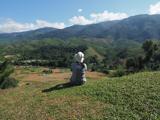 Fototapeta na wymiar woman relaxing with mountain view