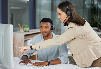 Day one as a call center agent, lets do this. Shot of a young man and woman using a computer while...
