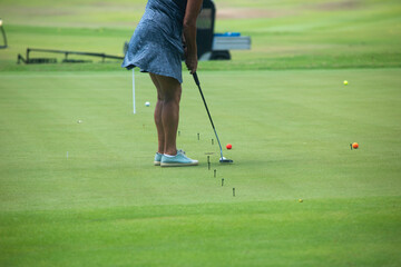 A rear view shot of active elderly woman playing golf and enjoying outdoor recreation in Mexico