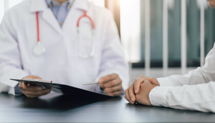 The doctor is conversation to the patient about the illness in the doctor's office and giving advice on health care. Concept of health problem consultation.