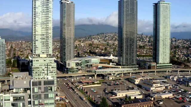 Brentwood Town Centre Station With Four High-rise Architectures With Traffic In The Road In Burnaby, Canada. - aerial