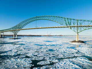 Laviolette Bridge, during winter, crossing the St. Lawrence River and ice floe in Trois-Rivieres,...