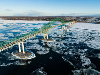 Laviolette Bridge, during winter, crossing the St. Lawrence River and ice floe in Trois-Rivieres,...