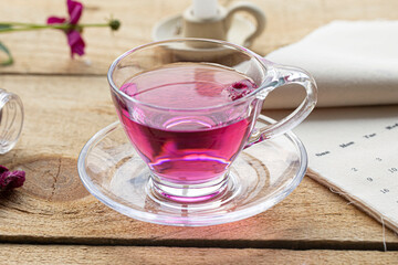 Petals in a clear glass cup of Petal tea. cockscomb tea
