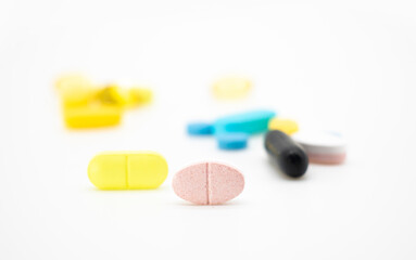yellow pills isolate on white background, selective focus
