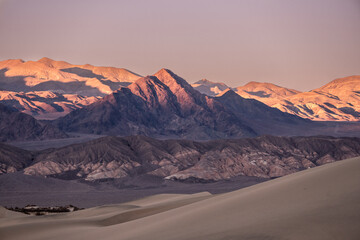 Fototapeta na wymiar Soft Shadows and Evening Light Drape The Grapevine Mountains From Mesquite Dunes