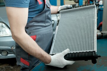 Car parts. Service in the car center. An auto mechanic inspects the integrity and compliance of the...