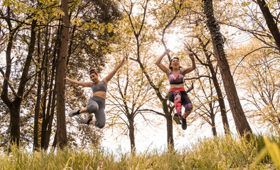 beautiful middle aged women jumping happy through the forest